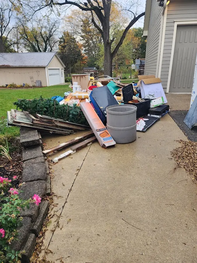 Dumpster being loaded with debris for Residential Dumpster Rental in Larned
